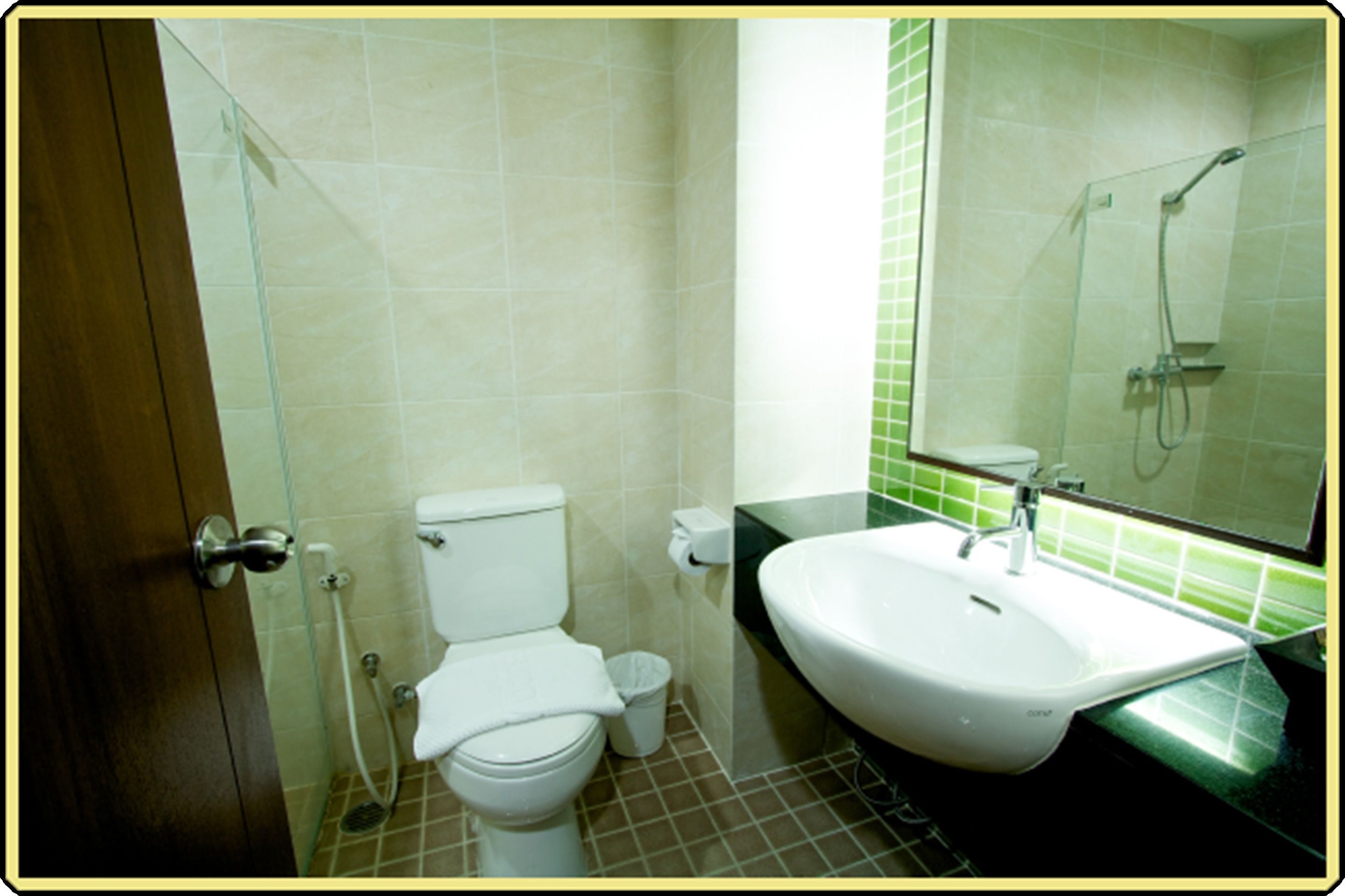 A bathroom with a toilet, sink, and shower.