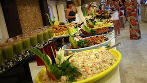 A buffet with various food items and drinks.