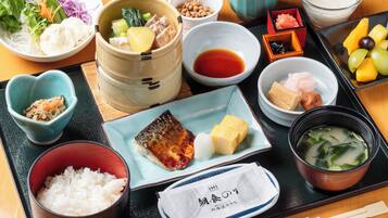 A variety of Japanese dishes including sushi, rice, and soup, arranged on a tray.