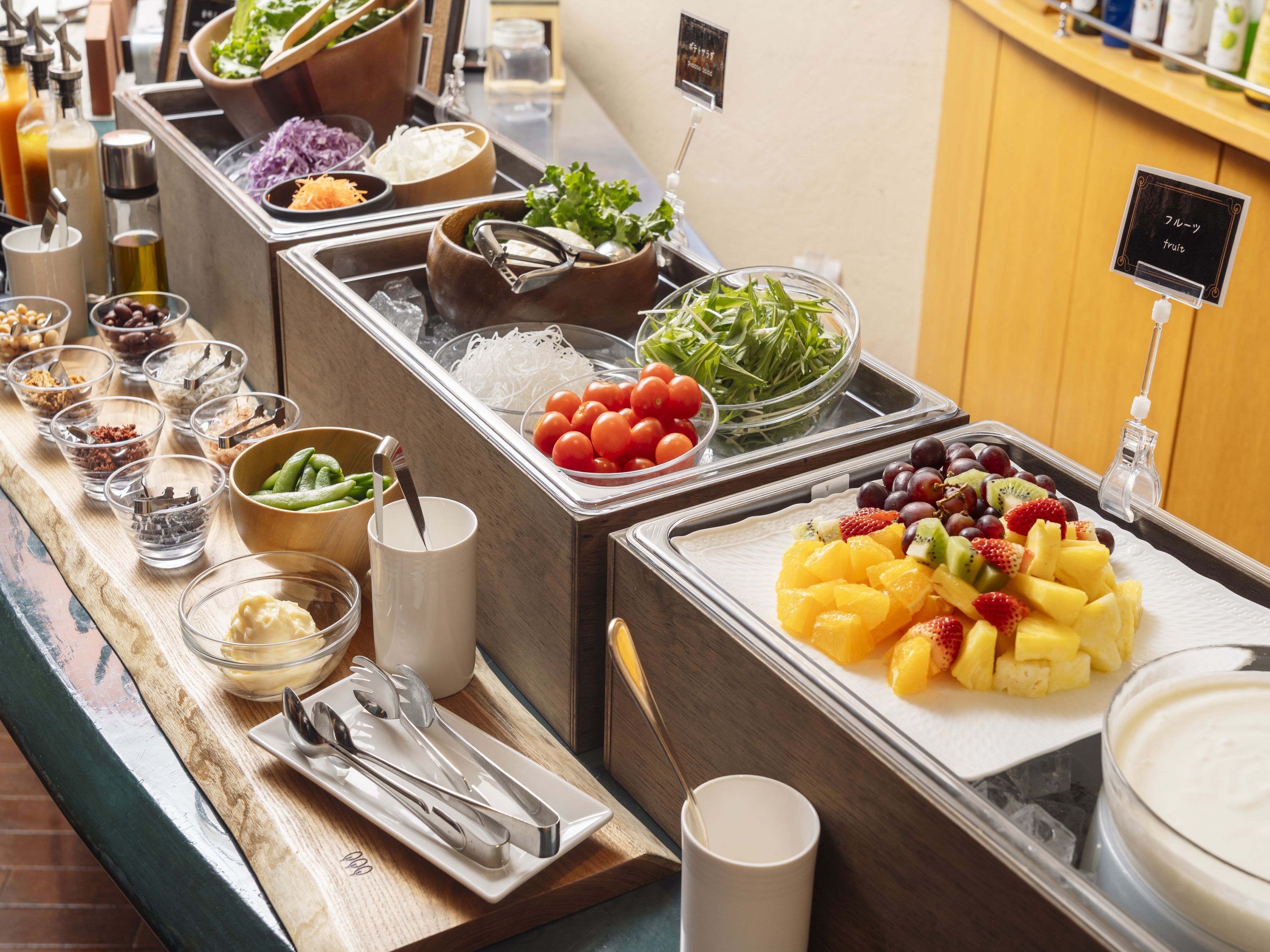 A buffet with various food items and condiments.