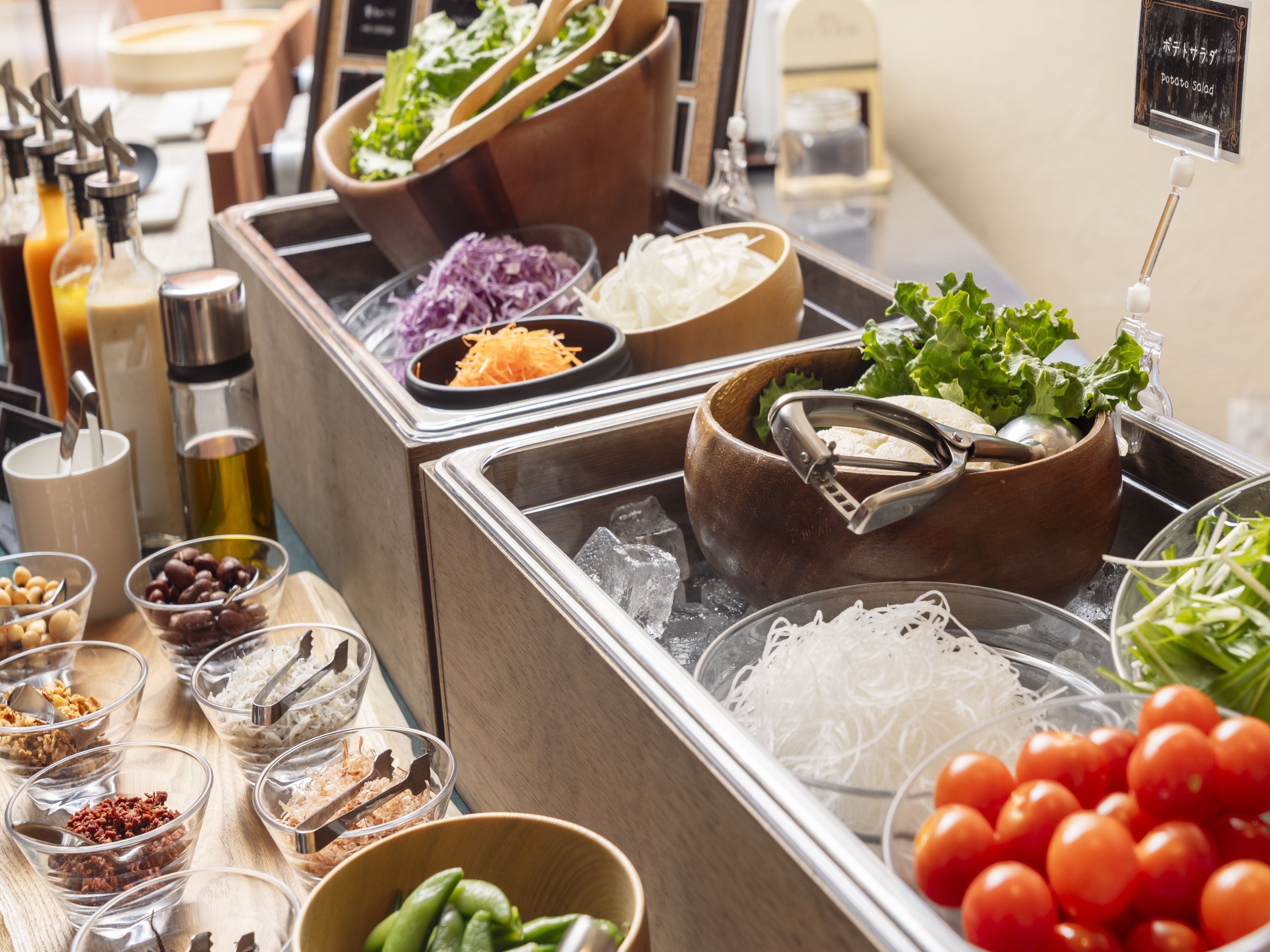A buffet with various food items and condiments.