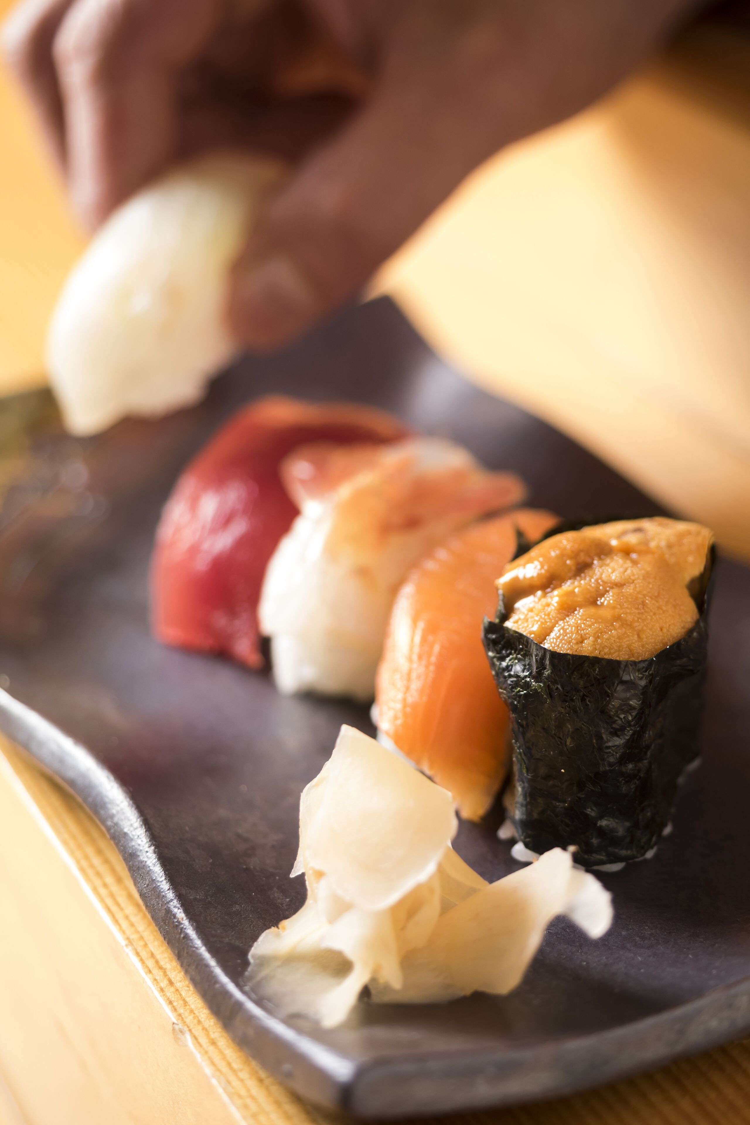 Un plato de sushi con diferentes tipos de pescado y acompañamientos.