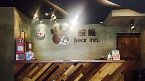 Una recepción con diseño de madera, un letrero que dice "Bear Inn" y una bandera británica.