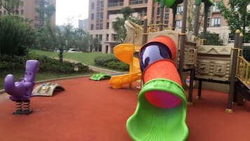 Children can play safely on the rubberized surface amidst climbing frames and slides.