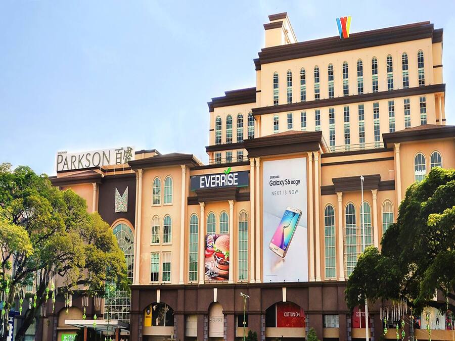 A multi-story building with a prominent sign for 'Everrise' and 'Parkson' on the facade.