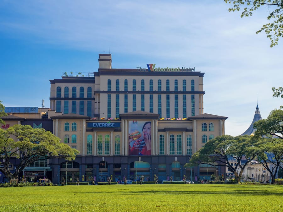 Un grand hôtel à étages, avec une enseigne Everrise bien visible et une grande publicité sur la façade.