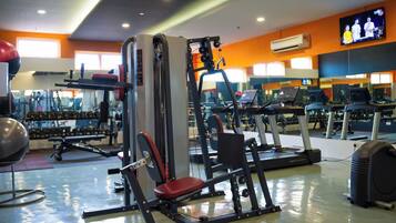A gym with various exercise equipment, including treadmills and weight machines.