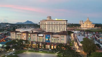 Experience the hotel's striking architecture with a view of the city's iconic landmark in the background.