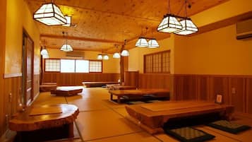 A traditional Japanese room with tatami mats, wooden furniture, and shoji screens.
