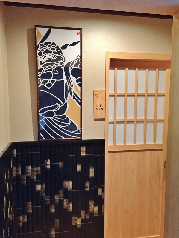 A traditional Japanese room with tatami flooring, a shoji screen door, and a framed artwork on the wall. - Ryokan Kato - Yoshino (Yoshino)