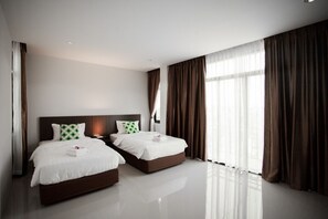 A modern hotel room with two beds, a large window with curtains, and a clean, minimalist design. - The Viewpoint Hotel (Phitsanulok)