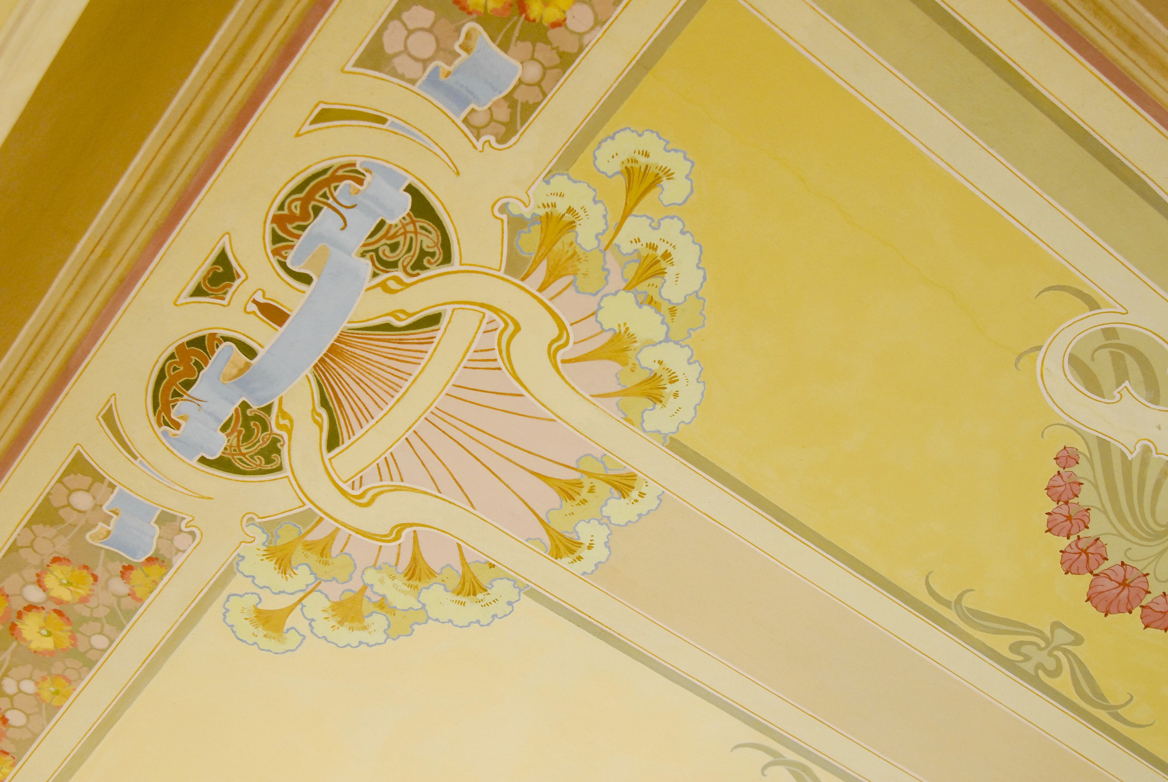 A ceiling with intricate floral and geometric patterns.