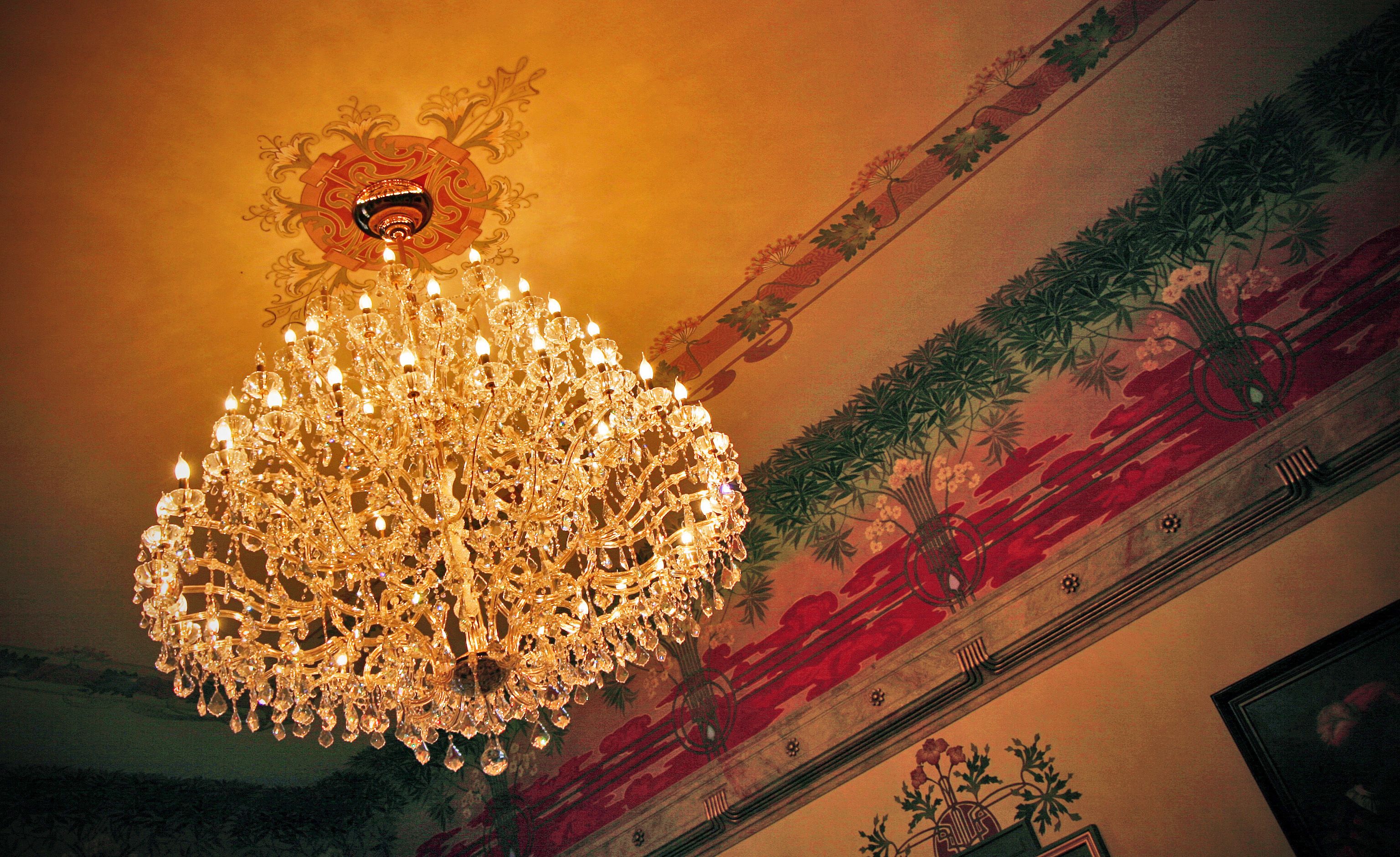 A chandelier with multiple light fixtures and crystal decorations.