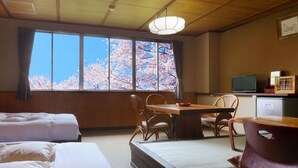 A traditional Japanese room with tatami flooring, a low wooden table, and a TV on a shelf. - Aizu Kitakata  Atsushioonsen YAMAGATAYA (Kitakata)