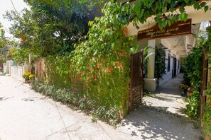 A building entrance with a sign reading "Blue Beach Village" and a welcome mat. - Blue Beach Village Homestay (Da Nang)