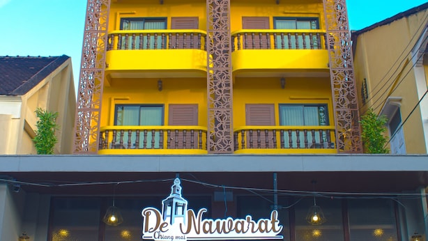 A multi-story building with balconies and a sign reading "De Nuwarat." - M Y Home Hotel (Chiang Mai)
