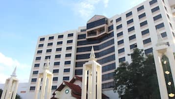 A multi-story hotel with a prominent entrance featuring a Play Palace sign.