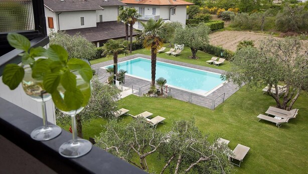 Um imóvel residencial com piscina, cadeiras de descanso e vista para montanhas.