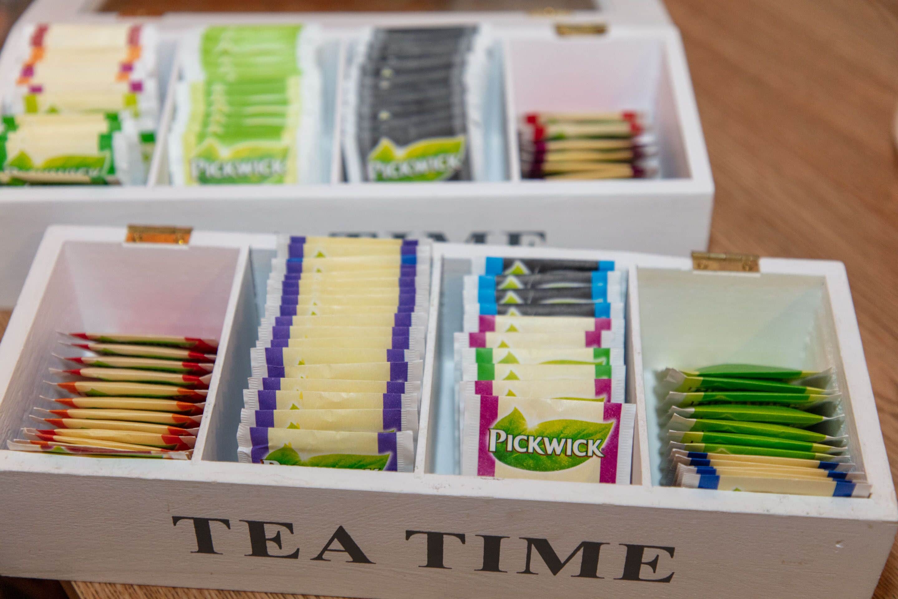 A box labeled "TEA TIME" containing various tea bags and matches.