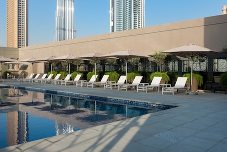 Outdoor pool, pool umbrellas, sun loungers. Rove Downtown Dubai