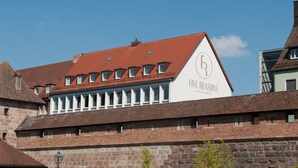 A building with a red-tiled roof and a sign that reads "Five Reasons Hotel & Hostel." - Five Reasons Hotel & Hostel (Nuremberg)