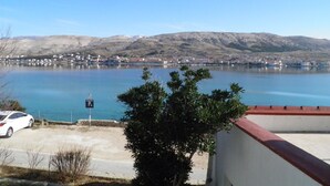 Vista de um lago, com uma área de estacionamento e um edifício ao primeiro plano.