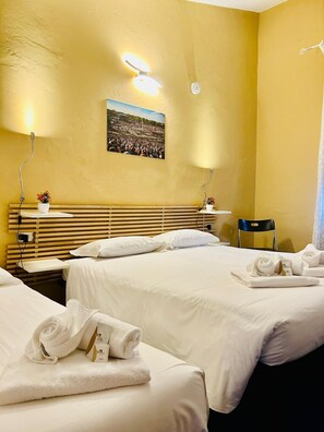 A hotel room with two beds, a wooden headboard, a wall-mounted picture, and a chair. - Smart Hotel Autodromo (Imola)