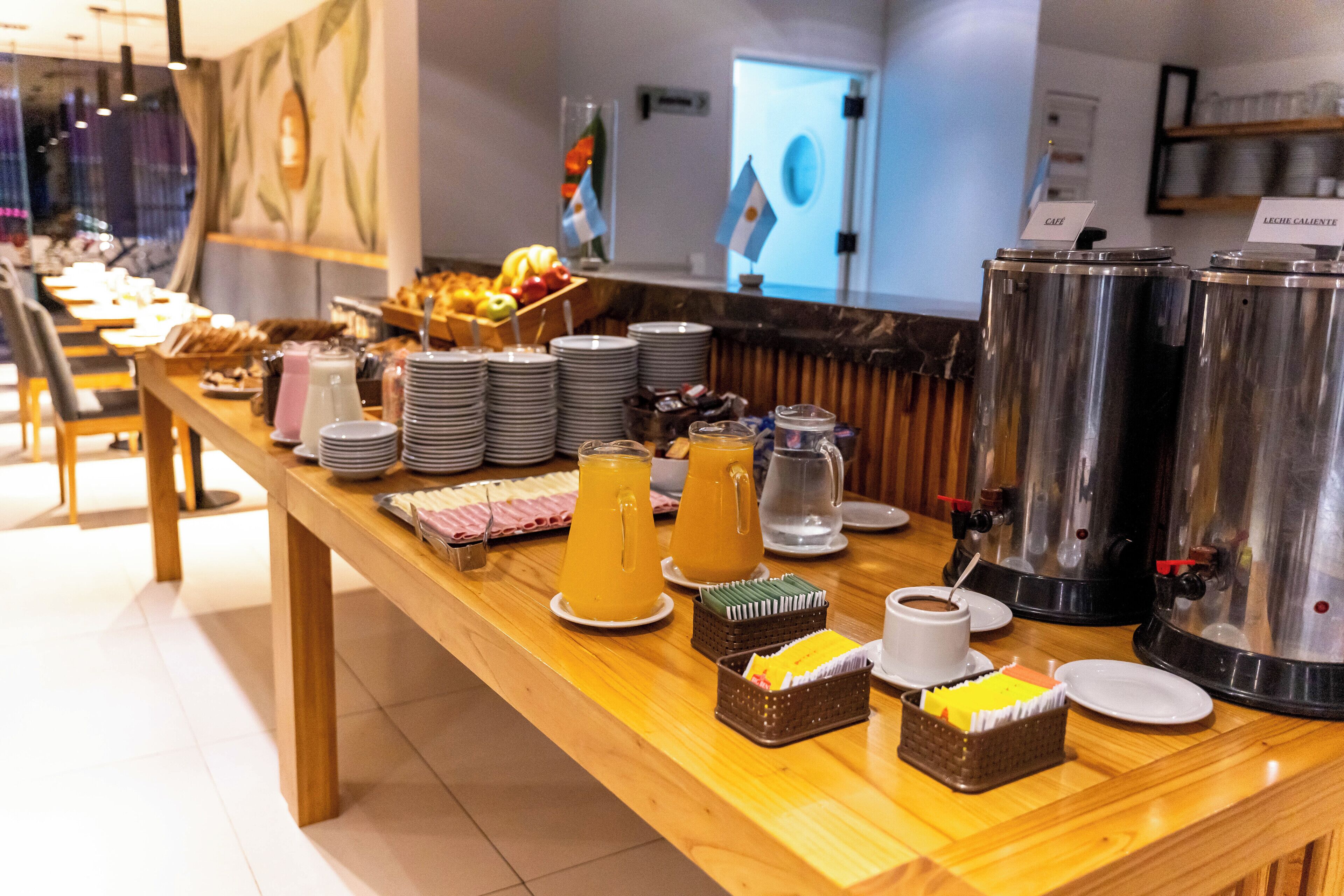 A buffet setup with various food items, beverages, and a coffee station.