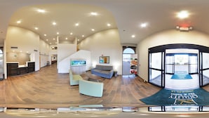 A spacious lobby with a reception desk, seating area, and a view of the outside. - Quality Inn & Suites Near Tanger Outlet Mall (Gonzales)