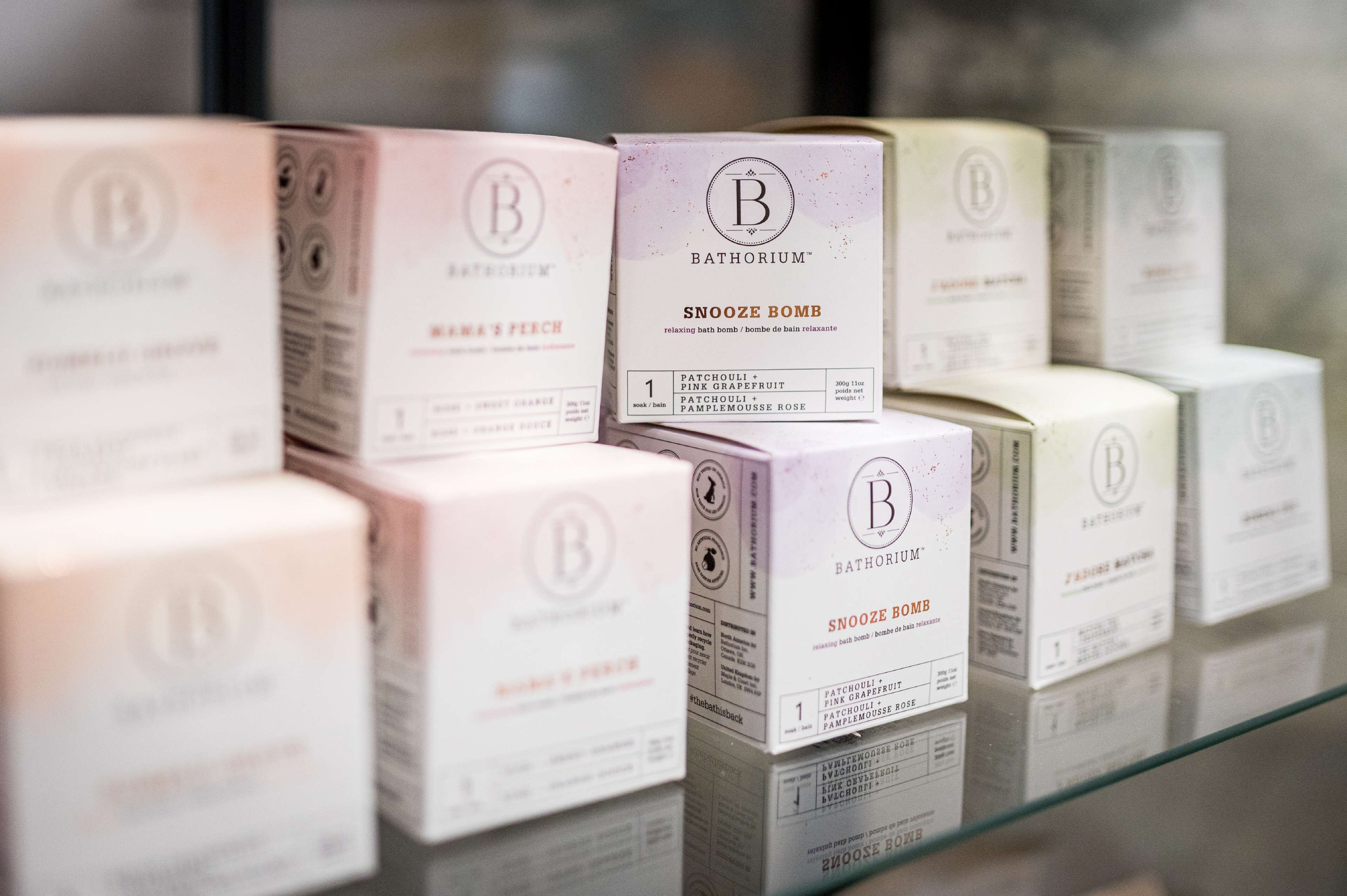 A display of Bathorium SNOOZE BOMB bath bombs in various scents.