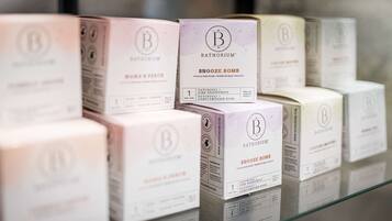 A display of Bathorium SNOOZE BOMB bath bombs in various scents.