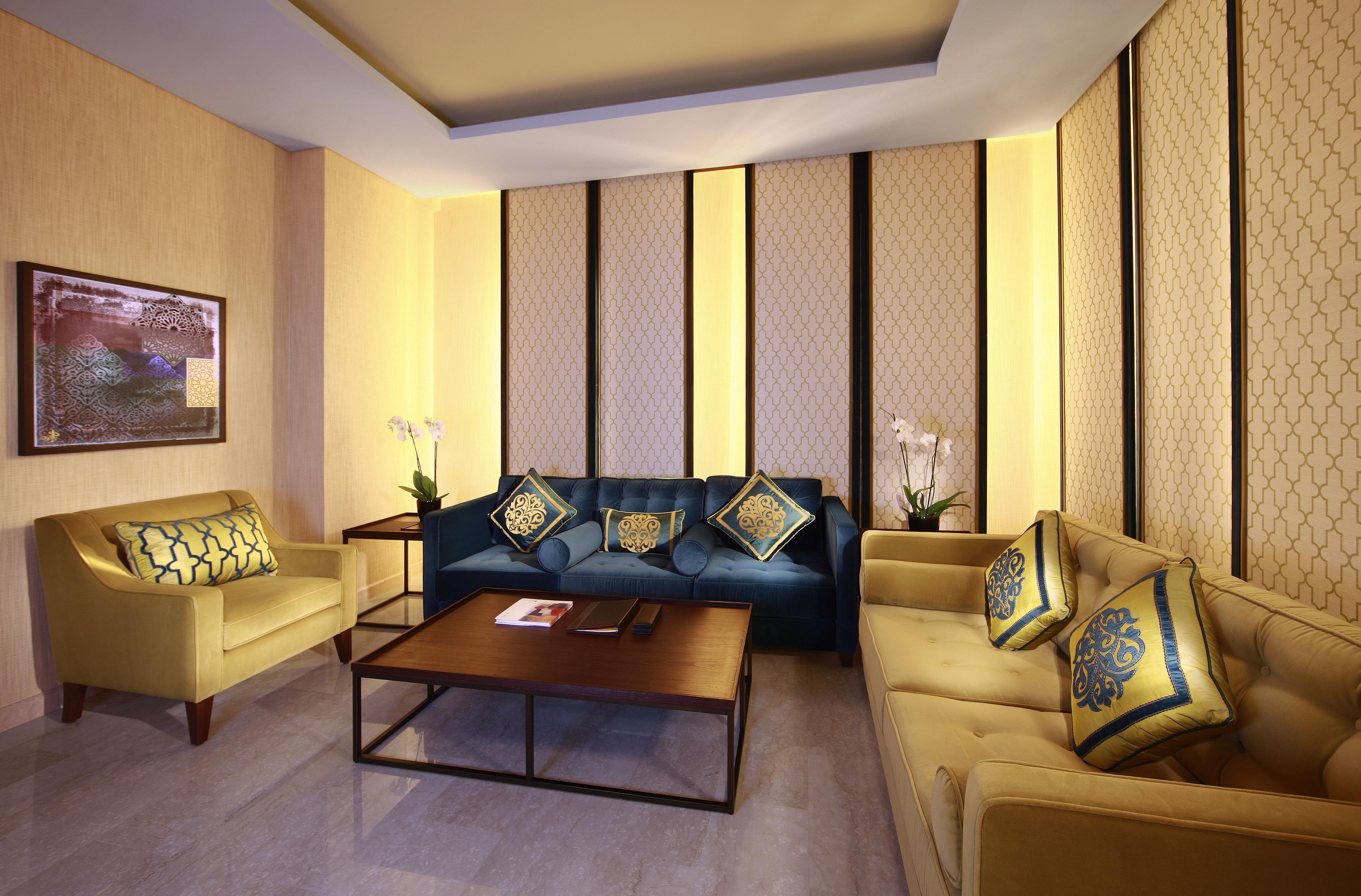 A modern living room with a sofa set, a coffee table, and decorative pillows.