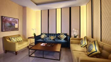 A modern living room with a sofa set, a coffee table, and decorative pillows.