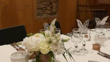 A table set with white flowers, clear glassware, and butterfly-shaped centerpieces.
