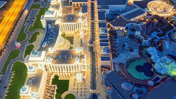 Stunning hotel complex with domed structures and a central courtyard, surrounded by beautifully landscaped gardens and pathways.