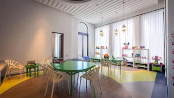 Children can play and socialize around a large table with comfortable seating.