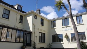 A two-story building with a sign reading "thermibrook". - The Millbrook B & B (Torquay)