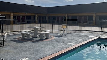 Relax by the pool with outdoor seating and a tiled edge.