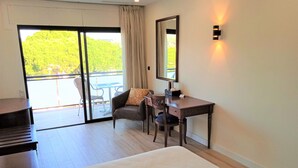 A hotel room with a bed, a desk, a chair, and a balcony with a table and chairs. - Hotel 153 (Castelldefels)