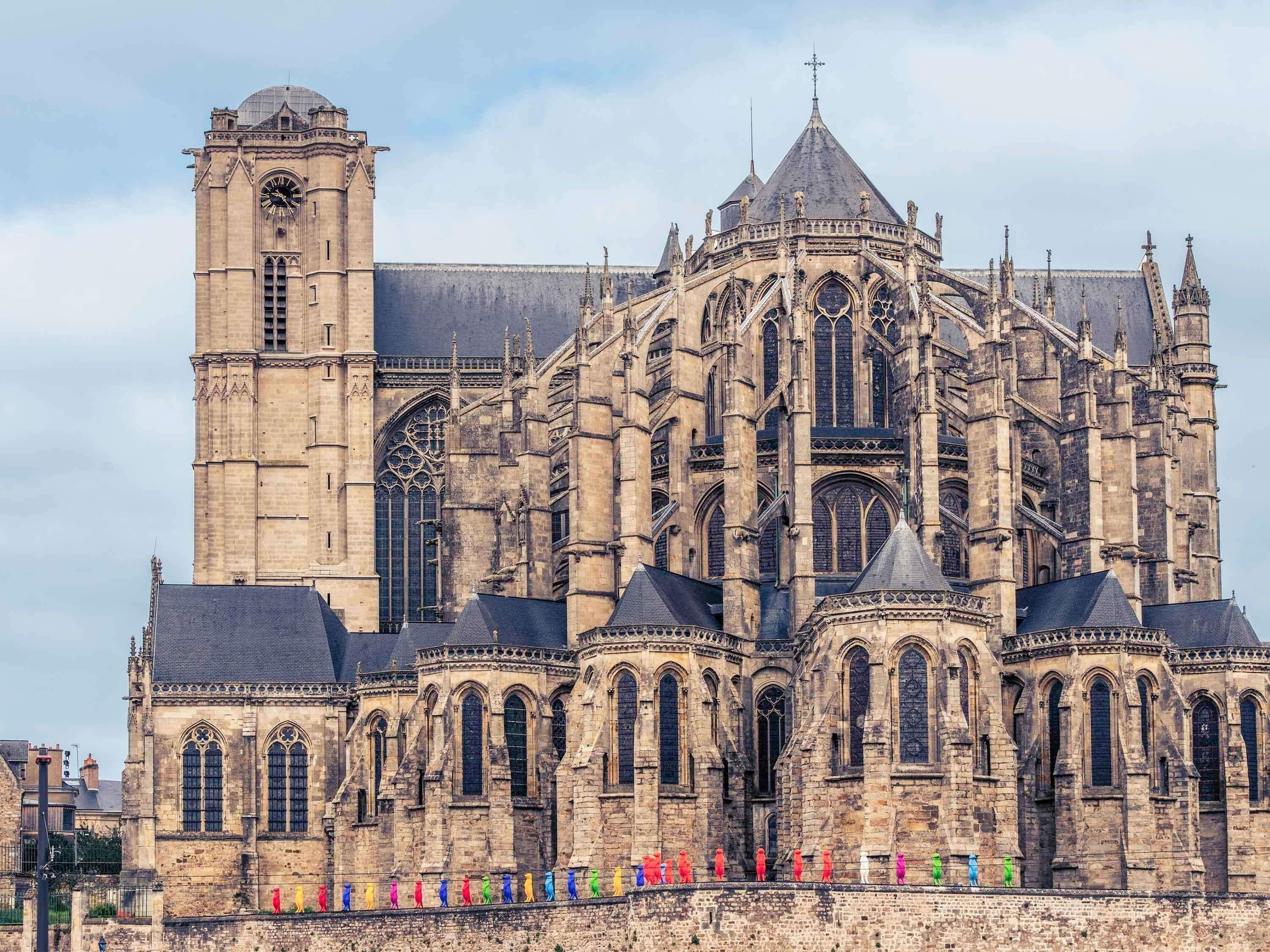 A historic cathedral with a prominent clock tower and intricate Gothic architecture.