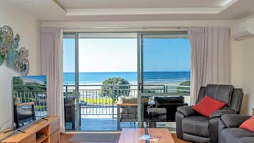 Deluxe Apartment, 1 Bedroom, Ocean View | Living area | 42-inch flat-screen TV with satellite channels, TV