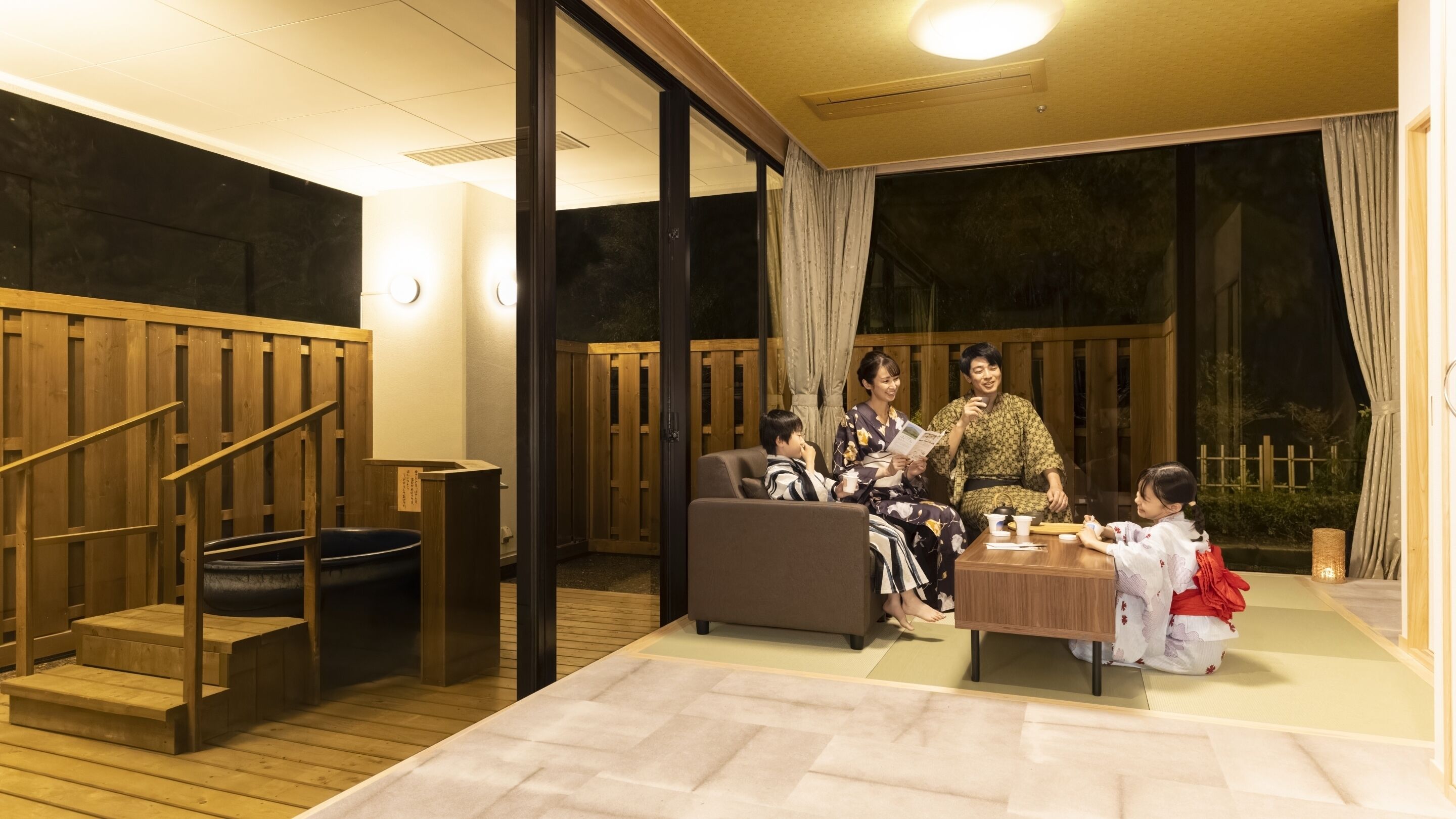 A traditional Japanese room with tatami flooring, a low wooden table, and a sliding door.