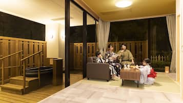 A traditional Japanese room with tatami flooring, a low wooden table, and a sliding door.