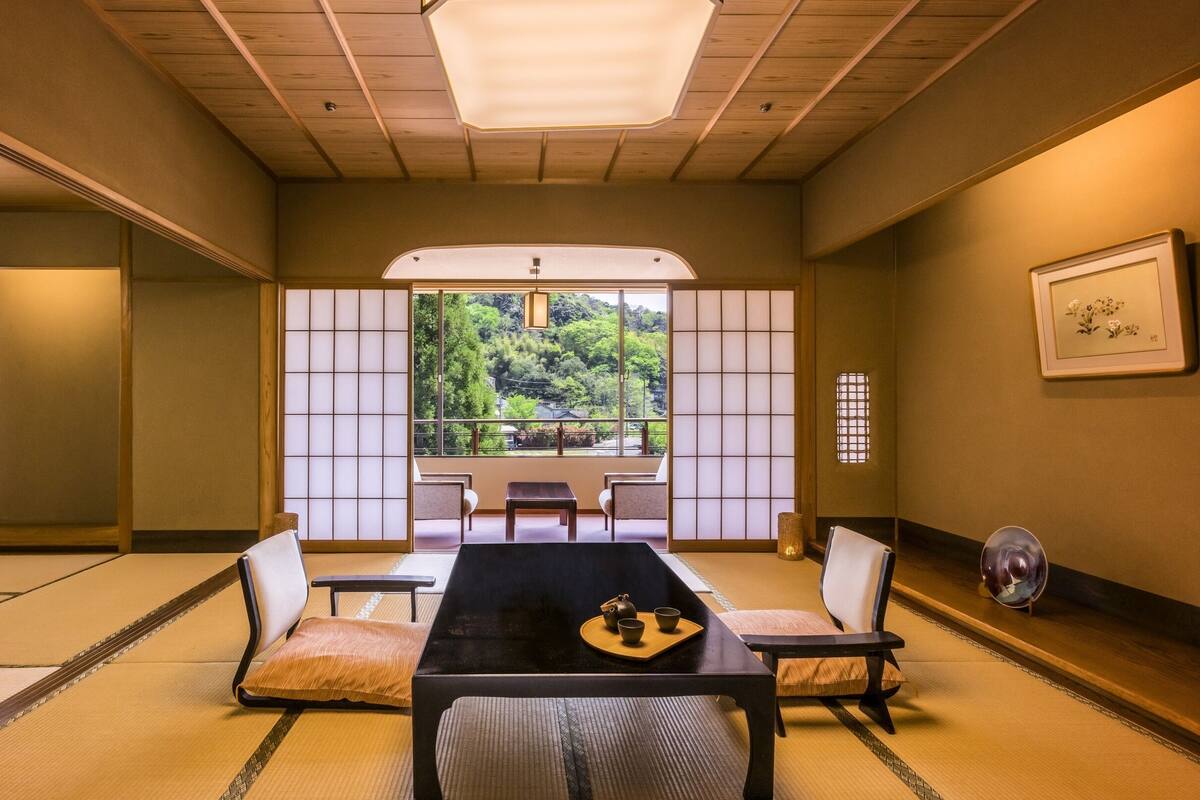 A traditional Japanese room with tatami flooring, a low table, and shoji screens.
