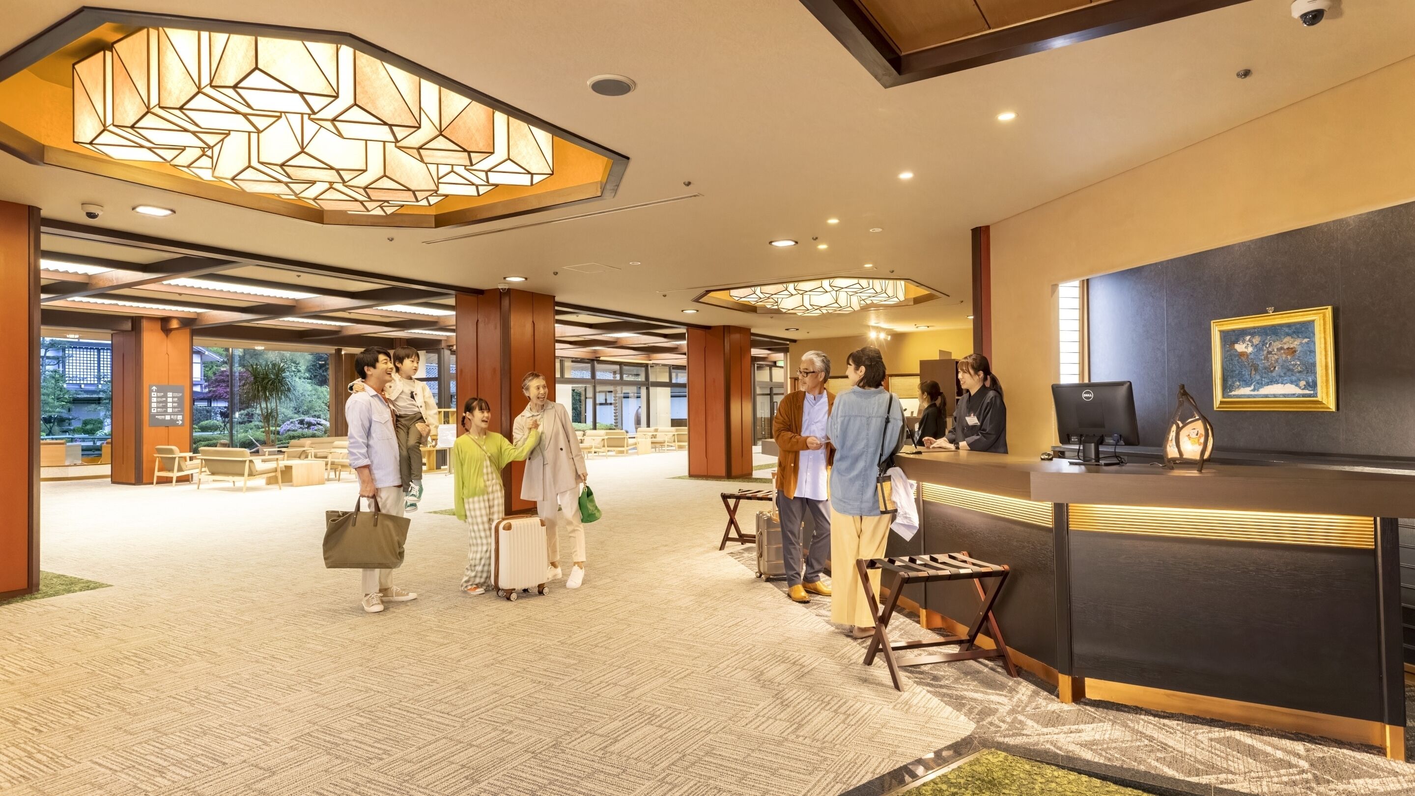 A hotel reception area with a modern design, including a reception desk, seating area, and a view of the outdoors.