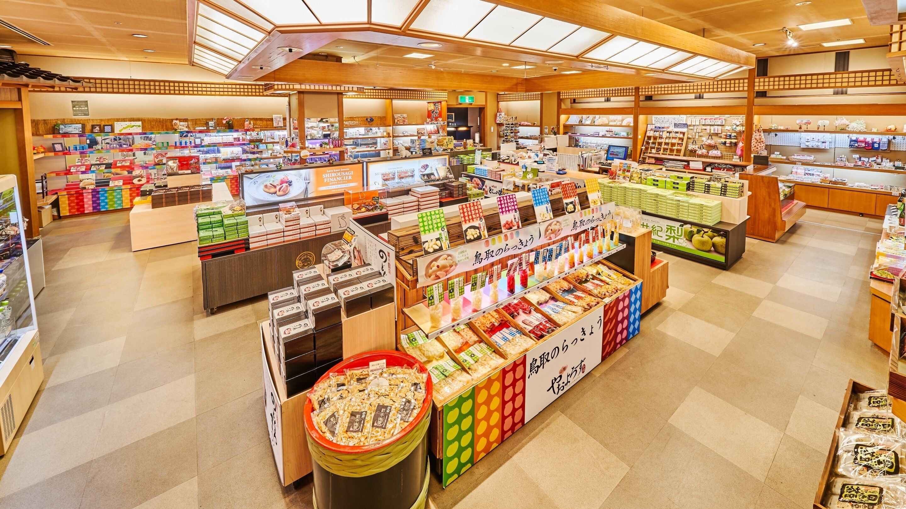 A spacious retail store with multiple aisles and a variety of products on display.