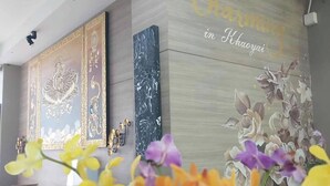 A reception area with a modern design, featuring a wall with floral artwork and the text "Charming in Khaoyai". - Charming in Khao Yai Hotel (Pak Chong)
