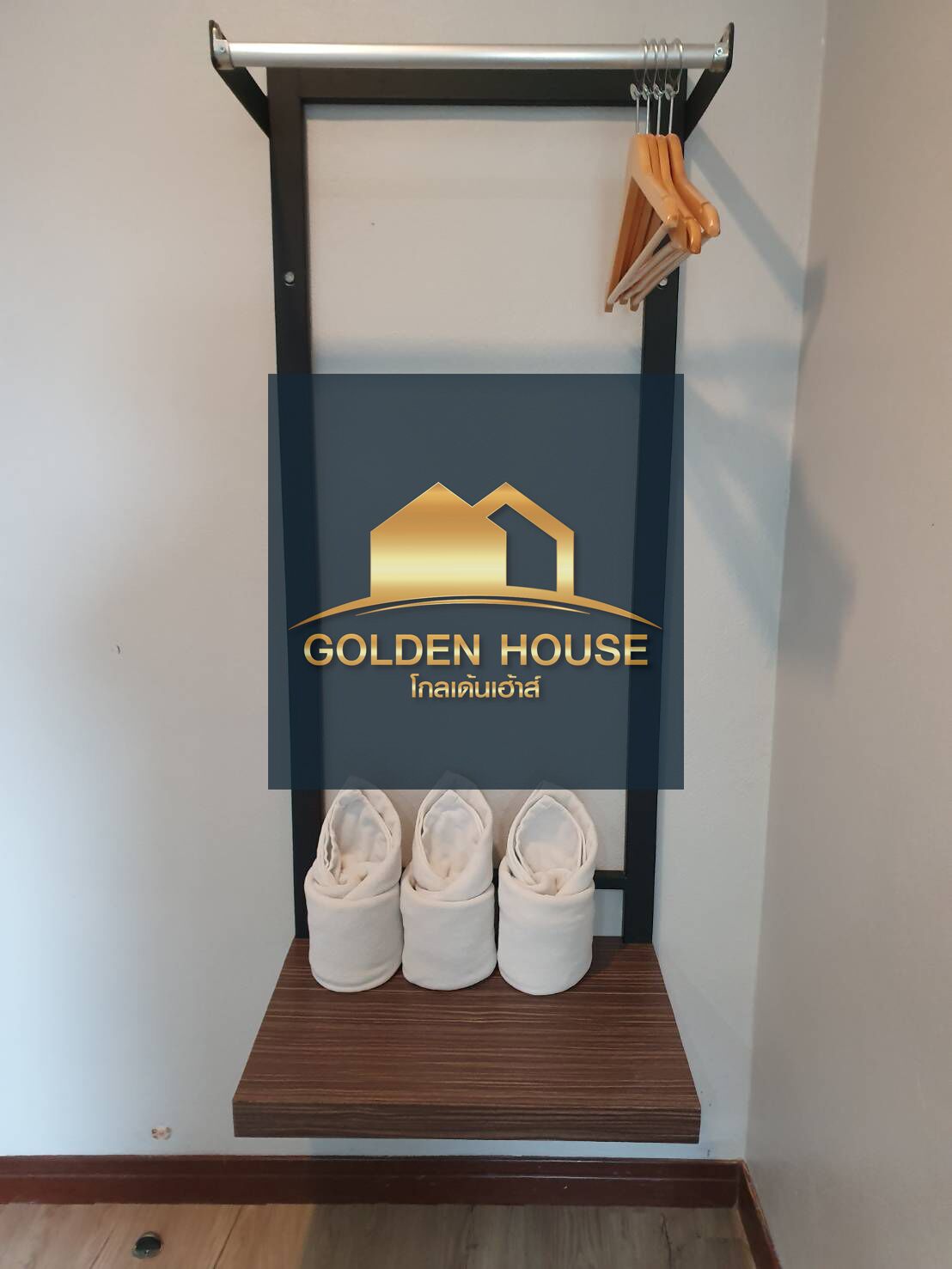 A display of Golden House with a logo, a wooden shoe rack, and three shoes.