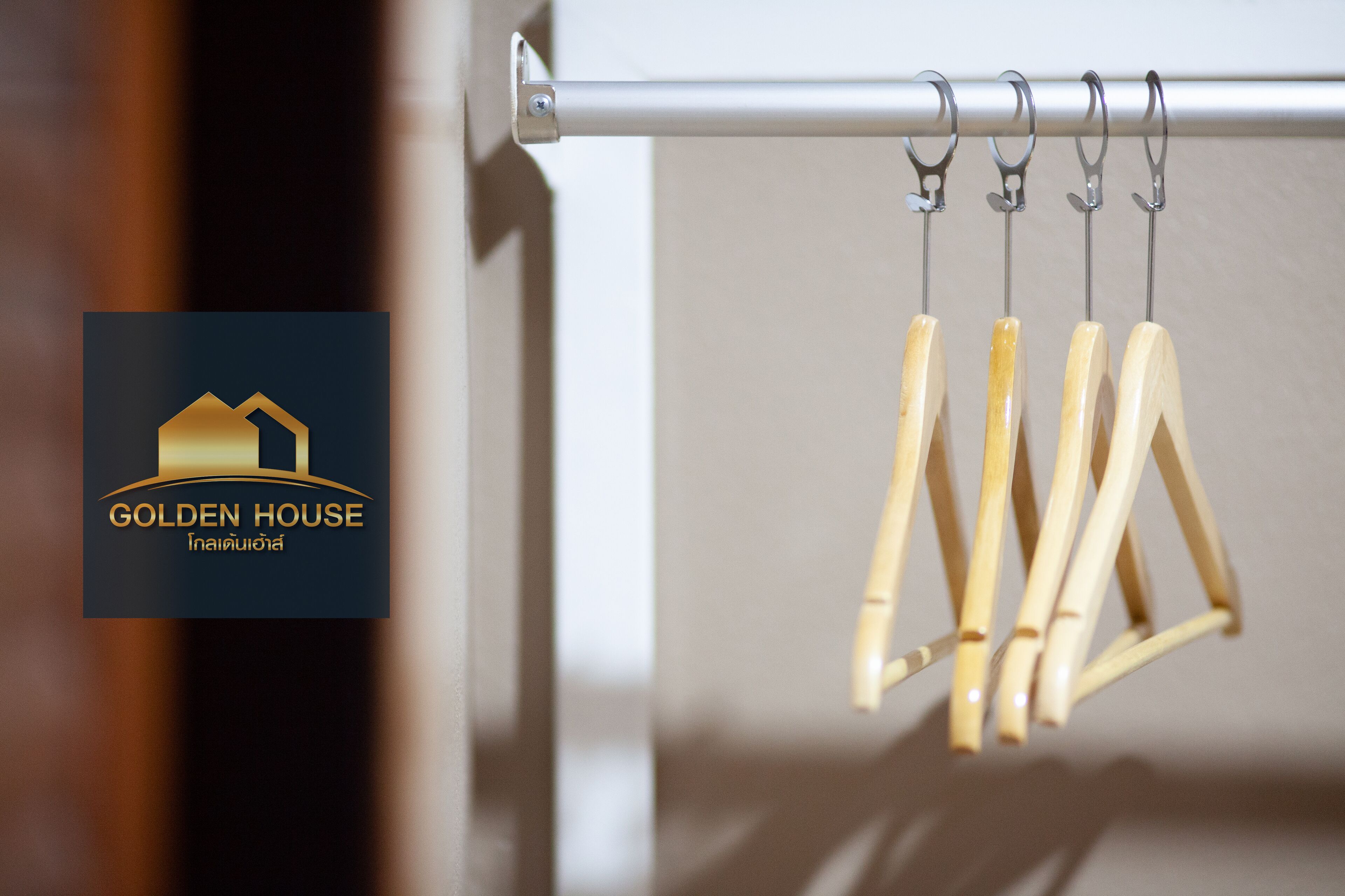 A metal rod with wooden clothespins hanging from it.