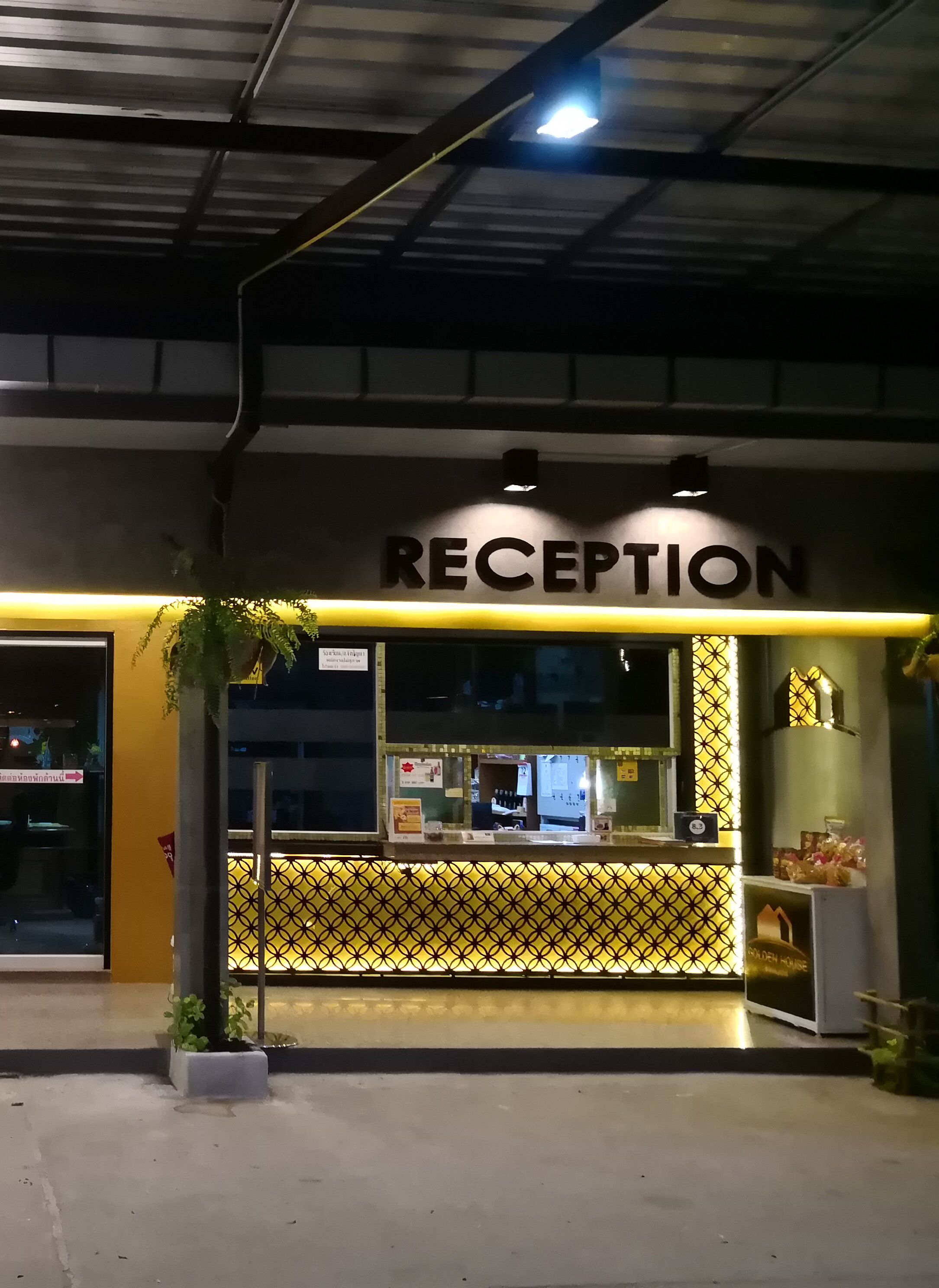 A reception area with a sign that reads "RECEPTION" and a patterned yellow and black design.